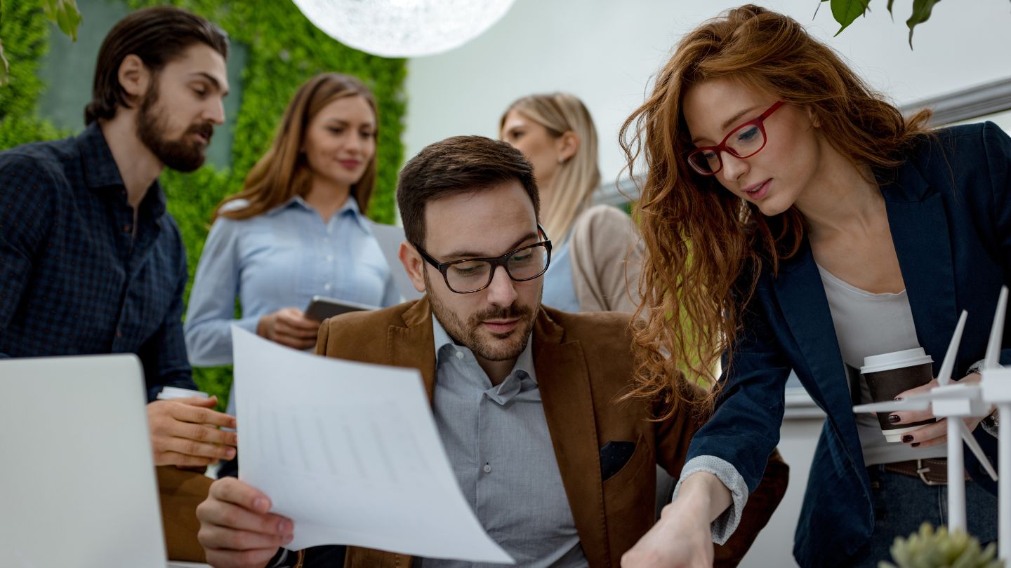 A group of professionals collaborate around a table